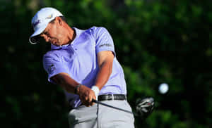 Tom Pernice Jr. Focused On Hitting A Golf Ball During A Tournament Wallpaper