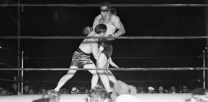 Tommy Loughran Delivering A Punch During A Boxing Match Wallpaper