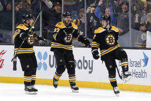 Torey Krug With Brad Marchand And Patrice Bergeron Wallpaper