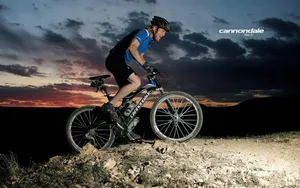 Tour De France Biker At Rocky Terrain Wallpaper