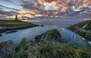 Tower Of Hercules Beneath The Cloudy Sunset Sky Wallpaper