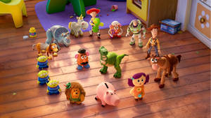 Toy Story Rex Surrounded By Friends Wallpaper