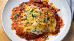Traditional Chicken Parmigiana In Marinara Sauce Wallpaper