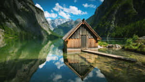 Tranquil Cabin By A River Wallpaper