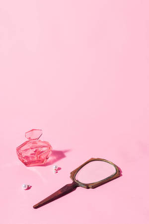 Trinkets On A Pink Color Wallpaper