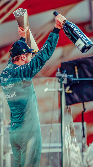 Triumphing Sebastian Vettel Celebrating His Victory Wallpaper