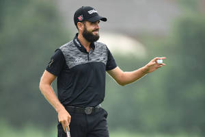 Troy Merritt Holding Out Golf Ball Wallpaper