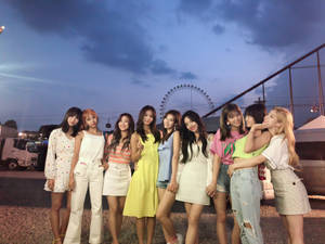 Twice In Dazzling 4k With Mesmerizing Ferris Wheel Backdrop Wallpaper