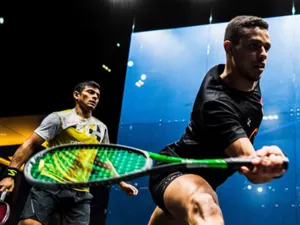 Two Athletic Boys Engaged In A Friendly Game Of Squash Wallpaper