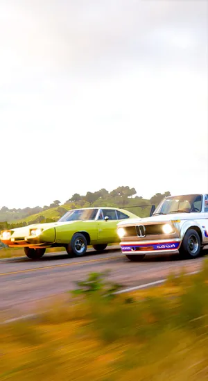 Two Cars Driving Down The Road Wallpaper