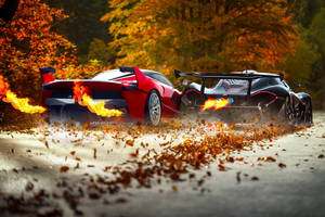 Two Ferrari Fire Cars On Autumn Road Wallpaper