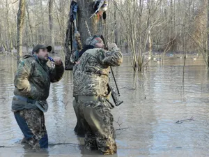 Two Men Standing In A Flooded Area Wallpaper