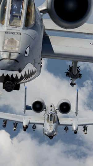 Two Military Jets Flying In The Sky With Their Mouths Open Wallpaper