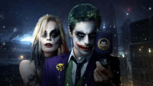 Two People Dressed As Joker And Batman Are Holding A Phone Wallpaper