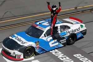 Tyler Reddick Standing On The Window Wallpaper
