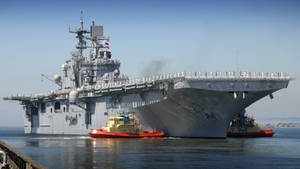 U S Navy Assault Ship Being Towed Wallpaper