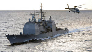 U S Navy Cruiser With Helicopter Wallpaper
