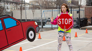 Unbreakable Kimmy Schmidt Kimmy With Stop Signage Wallpaper