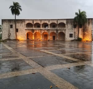 Unforgettable Beauty Of Alcazar De Colon Adorned With Palm Trees Wallpaper