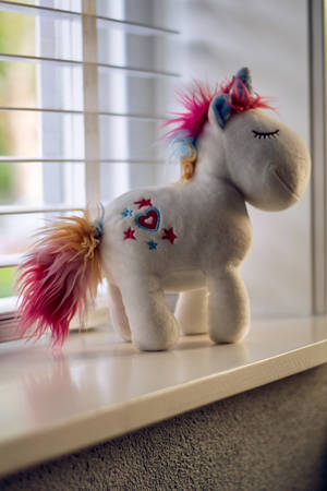 Unicorn Toy By The Window Wallpaper