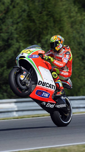 Valentino Rossi Racing On A Red Ducati Gp11 Wallpaper