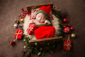 Very Cute Baby In Christmas Outfit Wallpaper