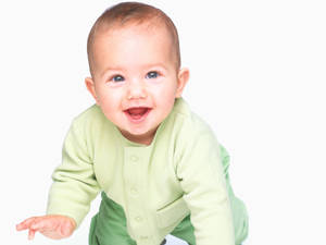 Very Cute Baby In Green Sweater Wallpaper