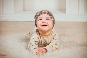 Very Cute Baby On Fluffy Rug Wallpaper
