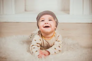 Very Cute Baby On Fluffy Rug Wallpaper