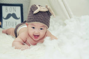 Very Cute Baby Wearing Beanie Hat Wallpaper