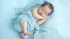 Very Cute Baby With Blue Blanket Wallpaper