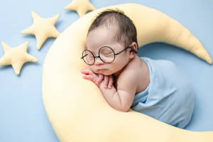 Very Cute Baby With Glasses Wallpaper