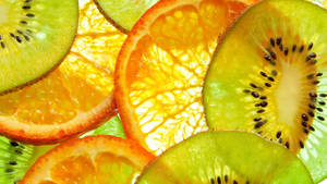 Vibrant And Fresh Kiwi And Orange Fruits Wallpaper