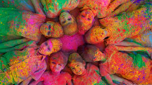 Vibrant Energy Of Holi - Children Enjoying The Festival Of Colors Wallpaper