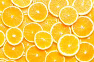 Vibrant Orange Citrus Slices Background Wallpaper