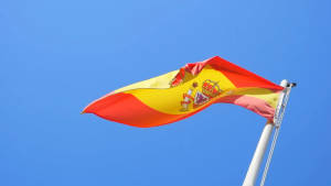 Vibrant Wavy Spain Flag On A Pole Wallpaper