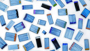 Vibrantly Colored Matchstick Tips Arranged In A Row. Wallpaper