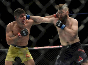 Vicente Luque Fiercely Battling It Out Inside The Octagon Wallpaper