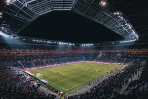 View From The First Row Of A Vibrant Soccer Stadium Wallpaper