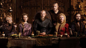Vikings Posing In Front Of Table Wallpaper