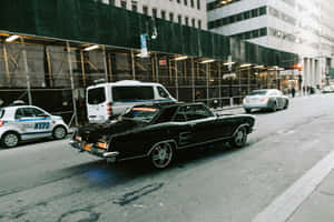 Vintage Black Muscle Car City Street Wallpaper