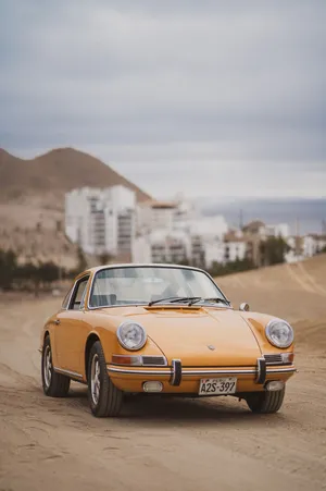 Vintage Porsche 912 Driving At A Desert Wallpaper