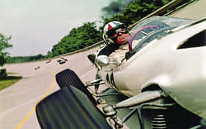 Vintage Racing Driver Speeding On Track Wallpaper