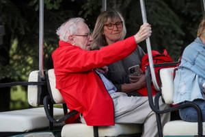 Warren Buffett Enjoying A Golf Cart Ride Wallpaper