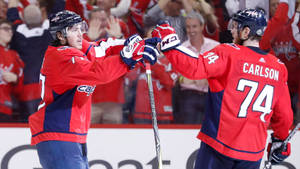 Washington Capitals John Carlson With Oshie On Field Wallpaper