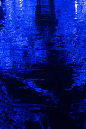 Waves Of Dark Blue Lap Against The Sandy Shoreline. Wallpaper