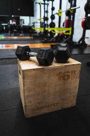 Weightlifting Dumbbells On Wooden Crate Wallpaper