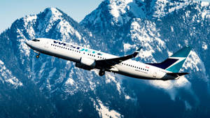 Westjet Airline Plane Over Mountains Wallpaper