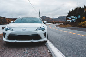 White Toyota Car In The Road Wallpaper