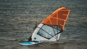 Windsurfing White And Orange Sail Wallpaper